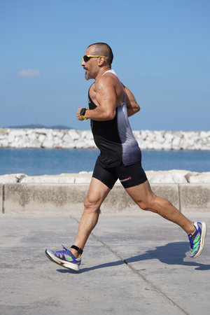 ISTANBUL, TURKIYE - JULY 02, 2022: Undefined athlete competing in running component of aquathlon during Maltepe Water Sports Festivalのeditorial素材