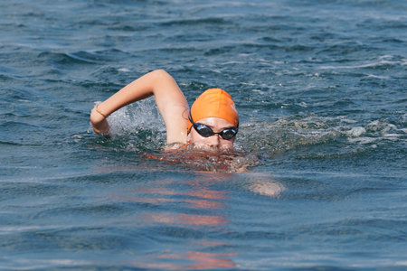 ISTANBUL, TURKIYE - JULY 02, 2022: Undefined athlete competing in swimming component of aquathlon during Maltepe Water Sports Festivalのeditorial素材