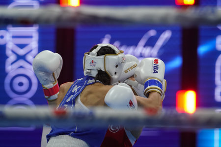 ISTANBUL, TURKEY - MAY 19, 2022: Cagirir Ayse (Red) and Balkibekova Alua (Blue) compete during IBA Womens World Boxing Championshipsのeditorial素材