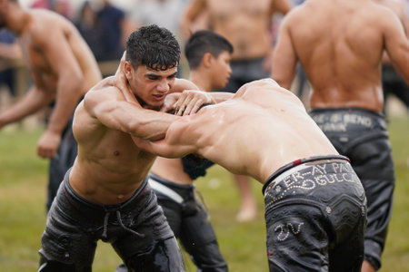 ISTANBUL, TURKIYE - JUNE 11, 2022: Oil wrestlers compete during Etnospor Culture Festival. Oil wrestling also called grease wrestling is the Turkish traditional sport.のeditorial素材