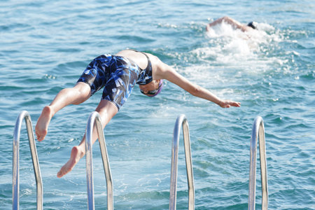ISTANBUL, TURKIYE - JULY 02, 2022: Undefined athlete competing in swimming component of modern pentathlon during Maltepe Water Sports Festivalのeditorial素材