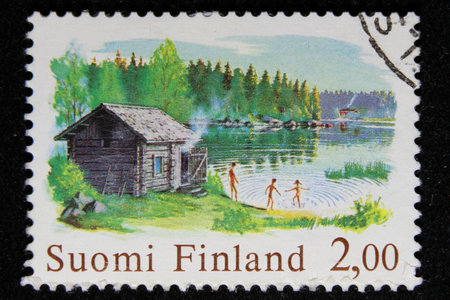 ISTANBUL, TURKEY - DECEMBER 25, 2020: Finland stamp shows Chimneyless Log Sauna circa 1974のeditorial素材