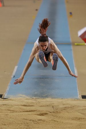 ISTANBUL, TURKEY - MARCH 05, 2022: Yana Sargsyan triple jumping during Balkan Athletics Indoor Championships in Atakoy Athletics Arenaのeditorial素材