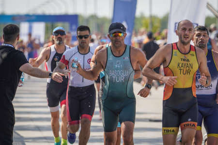 ISTANBUL, TURKIYE - JULY 02, 2022: Undefined athlete competing in running component of aquathlon during Maltepe Water Sports Festivalのeditorial素材