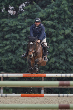 BURSA, TURKIYE - APRIL 09, 2023: Unidentified rider jumps with horse during the Turkish Equestrian Federation raceのeditorial素材