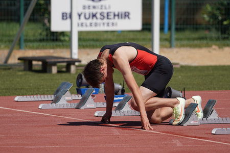 DENIZLI, TURKIYE - JULY 16, 2022: Undefined athlete running 100 metres during Balkan Athletics U20...