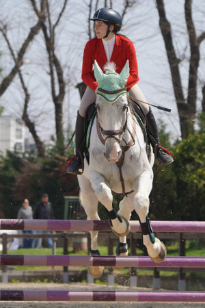 BURSA, TURKIYE - APRIL 08, 2023: Unidentified rider jumps with horse during the Turkish Equestrian Federation raceのeditorial素材