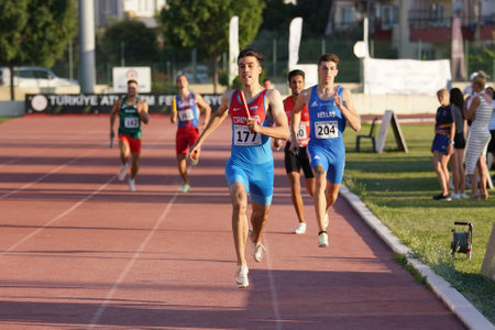 DENIZLI, TURKIYE - JULY 17, 2022: Athletes running 4x400 metres relay during Balkan Athletics U20 Championships in Denizli Albayrak Athletics Trackのeditorial素材