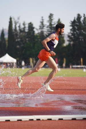 IZMIR, TURKIYE - JULY 05, 2023: Undefined athlete running 3000 metres steeplechase during Super...