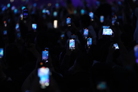 People are watching a concert with mobile phonesの写真素材