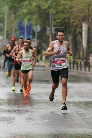 ISTANBUL, TURKIYE - APRIL 28, 2024: Athletes running Istanbul half marathon in historic street of...