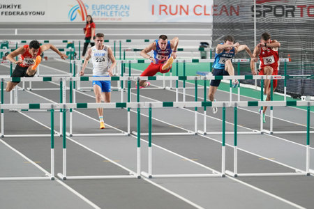 ISTANBUL, TURKIYE - FEBRUARY 10, 2024: Athletes running 60 metres hurdles during Balkan Athletics Championships in Atakoy Athletics Arenaのeditorial素材