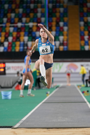 ISTANBUL, TURKIYE - FEBRUARY 10, 2024: Undefined athlete triple jumping during Balkan Athletics Championships in Atakoy Athletics Arenaのeditorial素材
