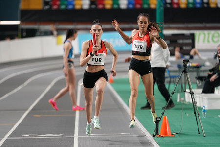 ISTANBUL, TURKIYE - FEBRUARY 10, 2024: Athletes running 4x400 metres relay during Balkan Athletics Championships in Atakoy Athletics Arenaのeditorial素材