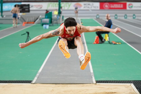 ISTANBUL, TURKIYE - FEBRUARY 10, 2024: Undefined athlete triple jumping during Balkan Athletics...