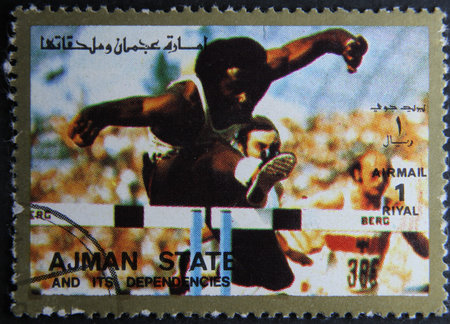 ISTANBUL, TURKEY - APRIL 17, 2021: Ajman State stamp shows Hurdling