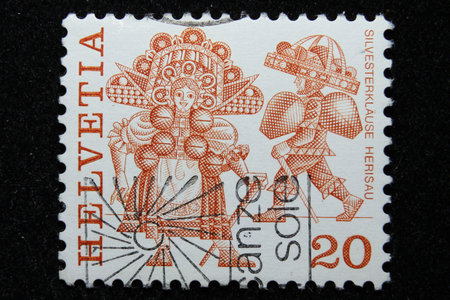 ISTANBUL, TURKEY - DECEMBER 25, 2020: Switzerland stamp shows New Years Eve costumes, Herisau circa 1977のeditorial素材