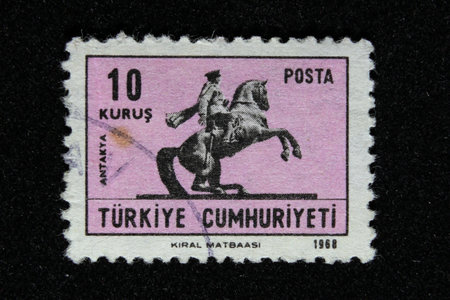 ISTANBUL, TURKEY - DECEMBER 25, 2020: Turkish stamp shows Equestrian Statue of Ataturk in Antakya...