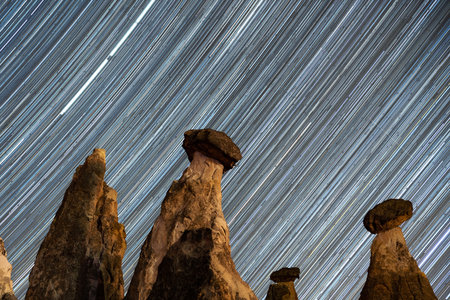 Star Trails over Fairy Chimneys in Cappadocia, Nevsehir City, Turkiyeの写真素材