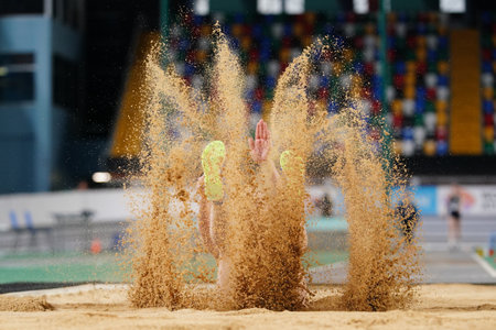 ISTANBUL, TURKIYE - FEBRUARY 23, 2025: Undefined athlete triple jumping during Turkish Indoor Athletics Championships in Atakoy Athletics Arenaのeditorial素材