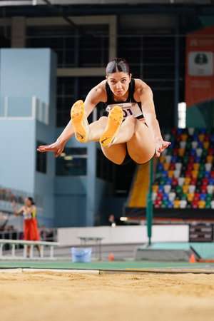 ISTANBUL, TURKIYE - FEBRUARY 22, 2025: Undefined athlete long jumping during Turkish Indoor Athletics Championships in Atakoy Athletics Arenaのeditorial素材