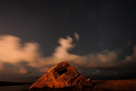 Stars and Comet over bunker during nightの写真素材