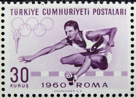 ISTANBUL, TURKEY - JANUARY 03, 2021: Turkish stamp shows 17th Olympic Games, Rome, Hurdling circa 1960のeditorial素材
