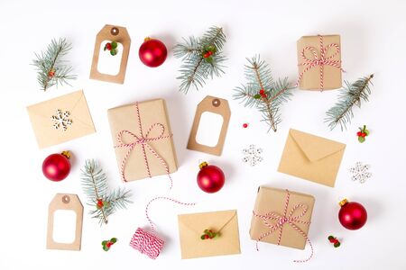 Christmas composition. Christmas gift, pine branch, and red berries. Top view, flat lay, copy spaceの写真素材