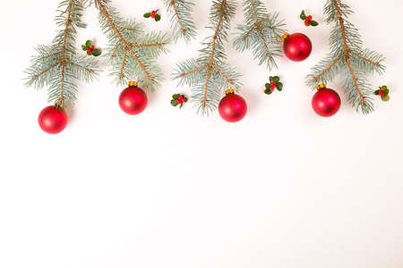 Christmas composition. Christmas gift, pine branch, and red berries. Top view, flat lay, copy spaceの写真素材