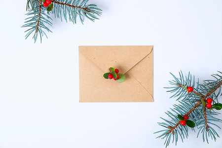 Christmas composition. Christmas gift, pine branch, and red berries. Top view, flat lay, copy space.の写真素材