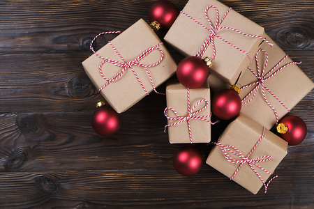 Christmas gifts box with red balls on a wooden backgroundの写真素材