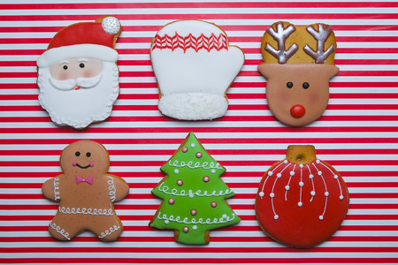 Christmas cookies on stripe background top view. Various types of christmas gingerbread cookies flat lay. Christmas characters cookies. Christmas cookies backgroundの写真素材