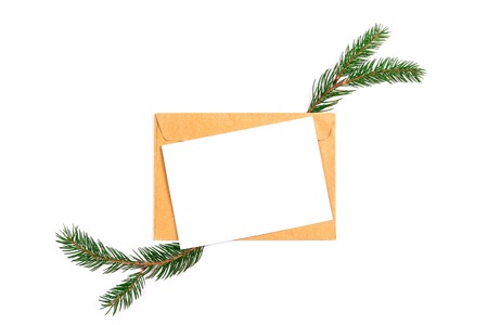 Festive flat lay composition with blank invitation for new year celebration and craft paper envelope. Christmas greeting card template concept. Background, copy space, top view.の写真素材