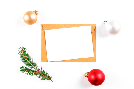 Festive flat lay composition with blank invitation for new year celebration and craft paper envelope. Christmas greeting card template concept. Background, copy space, top view.の写真素材