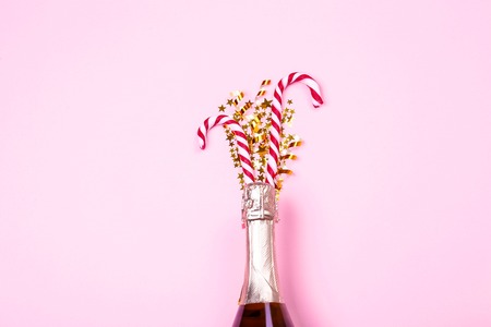 Festive composition with champagne & golden glitter. Traditional New Year celebration. Winter holiday season, christmas time concept. Greeting card mock up. Background, top view, copy space, flat lay.の写真素材