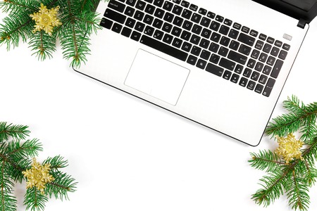 Online shopping for winter holidays concept. Flat lay composition with white laptop, black keyboard and traditional festive Christmas decoration. Close up, copy space, background, top view.の写真素材
