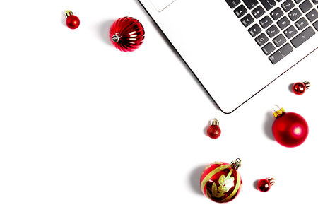 Online shopping for winter holidays concept. Flat lay composition with white laptop, black keyboard and traditional festive Christmas decoration. Close up, copy space, background, top view.の写真素材