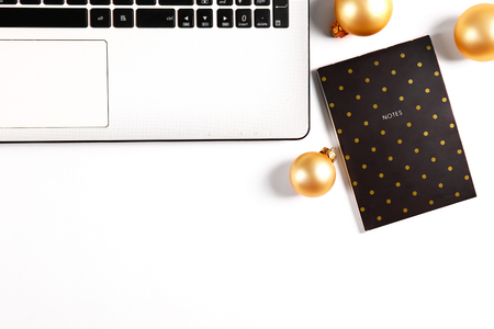Online shopping for winter holidays concept. Flat lay composition with white laptop, black keyboard and traditional festive Christmas decoration. Close up, copy space, background, top view.の写真素材