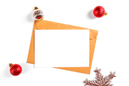 Festive flat lay composition with blank invitation for new year celebration and craft paper envelope. Christmas greeting card template concept. Background, copy space, top view.の写真素材