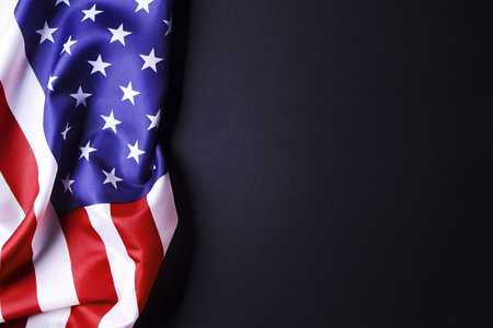 Patriotic composition w/ ruffled American flag on black background. United States of America stars & stripes symbol with copy spase for text. 4th of july Independence day concept. Background, close upの写真素材