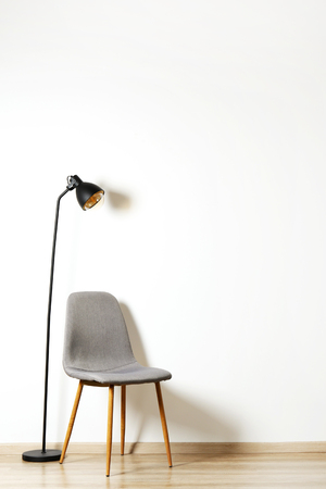 Empy loft style chair over blank wall background wit a lot of copy space for text. Available job position, interview or negotiations concept.の写真素材