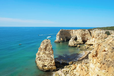 Rocky beaches with cliffs somwhere, somwhere in Algarve, Portugal. Atlantic ocean shore background....