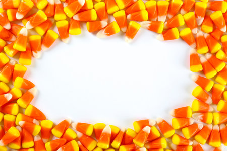 Bunch of candy corn sweets as sybol of Halloween hoiday on textured background with a lot of copy...