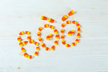 Bunch of candy corn sweets as sybol of Halloween hoiday on textured background with a lot of copy...