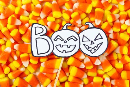 Bunch of candy corn sweets as sybol of Halloween hoiday on textured background with a lot of copy...