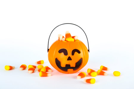 Bunch of candy corn sweets as sybol of Halloween hoiday on textured background with a lot of copy...