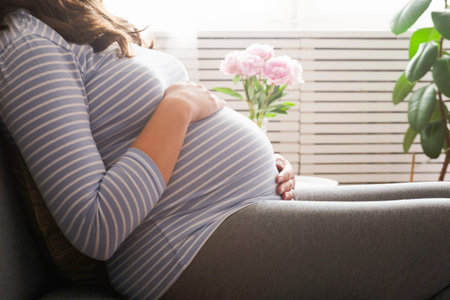 Portrait shot of young beautiful woman on third trimester of pregnancy. Close up of pregnant female...