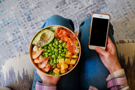 Clean eating diet concept. Vegeterian seafood bowl with smoked salmon, shrimp, avocado in take out...