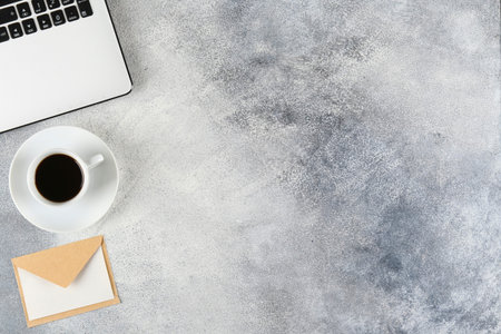 Cropped shot of black and white laptop keyboard with stationery accessories. Workspace of designer...