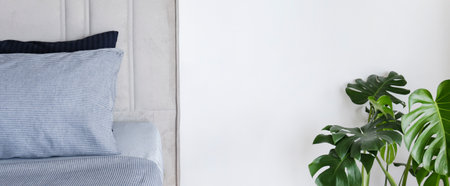 room with freshly made king sized bed with headboard, perfectly clean and ironed sheets, puffy pillows in natural sun light. Kingsize bed in a furniture showroom. Close up, copy space for text.の写真素材